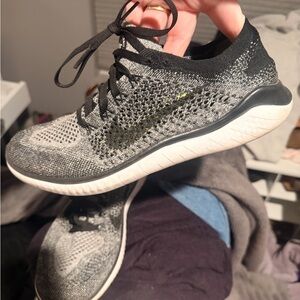 Nike Womens Gray and Black Flyknit Athletic Shoes with Subtle Yellow Swoosh